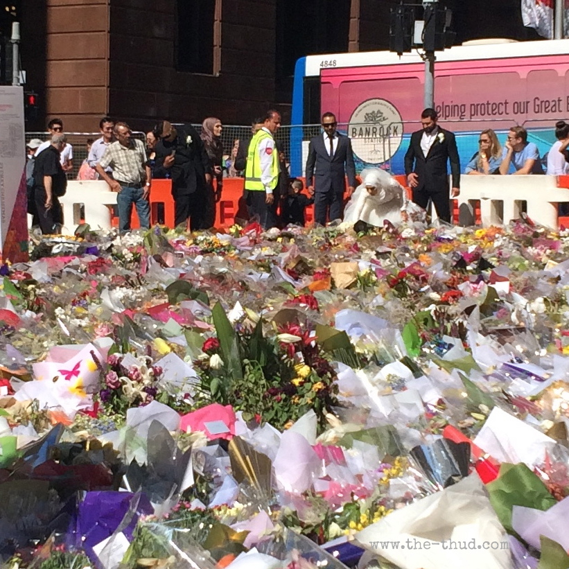 A Muslim bride lays her bridal bouquet at the flower memorial at Martin Place in Sydney. Site of the Lindt Cafe siege.